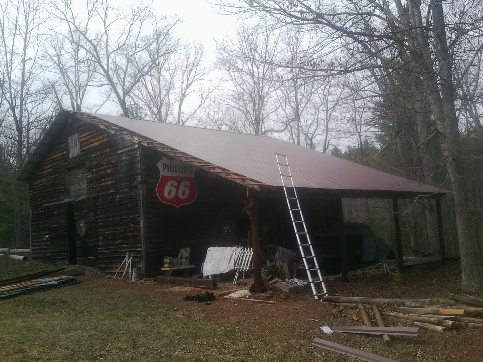 New metal roof on an open sided timber barn with a vintage sign in Coal Center